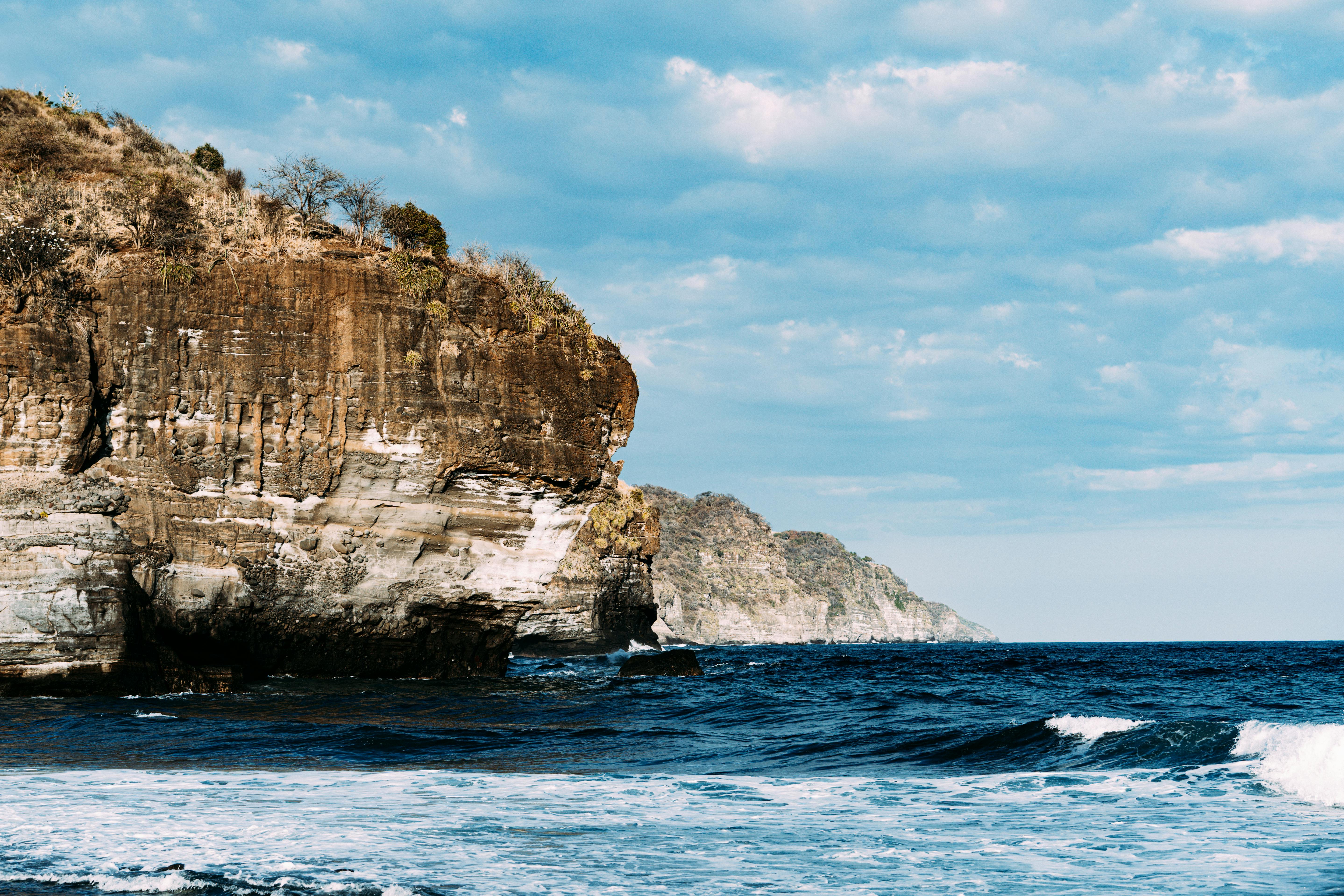 Photographer walking with camera strap across shoulder