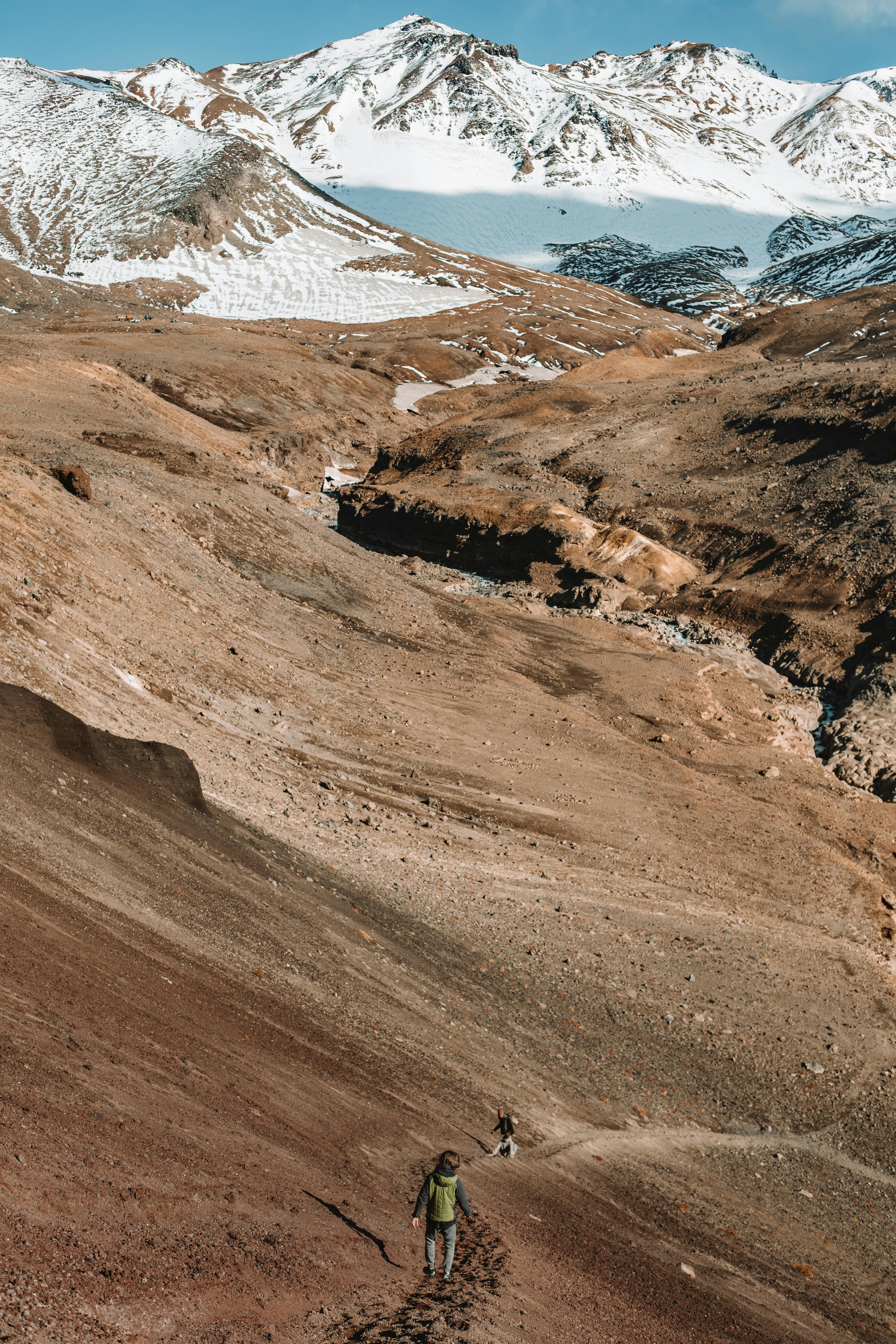 Hiker with a lightweight camera setup overlooking a mountain landscape at sunrise