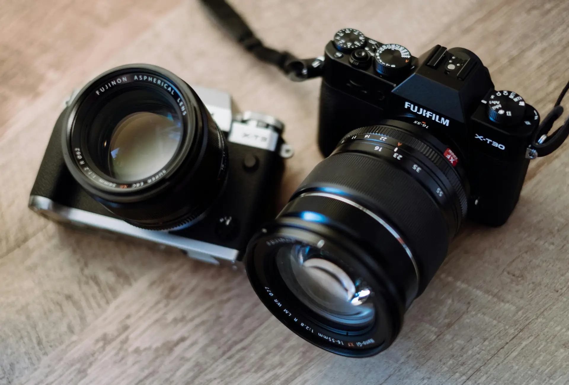 Selection of compact and mirrorless cameras laid out for travel