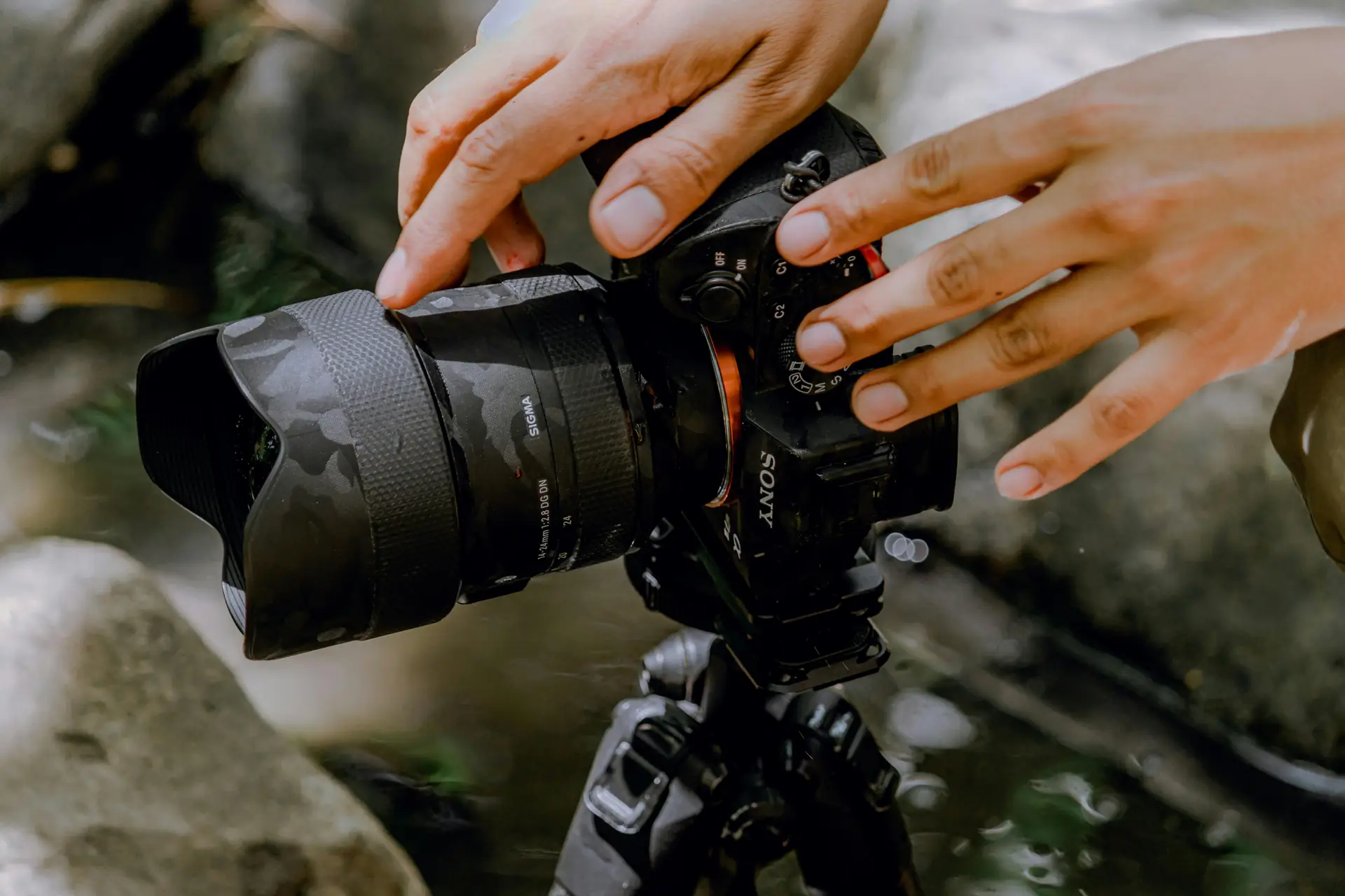 Photographer adjusting a crossbody camera strap while walking