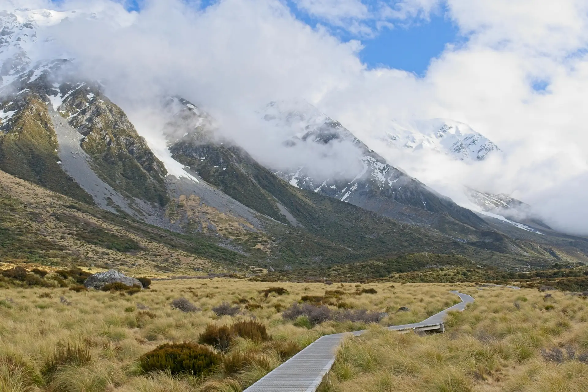 Photographer tucking camera under pack strap with quick-release mount