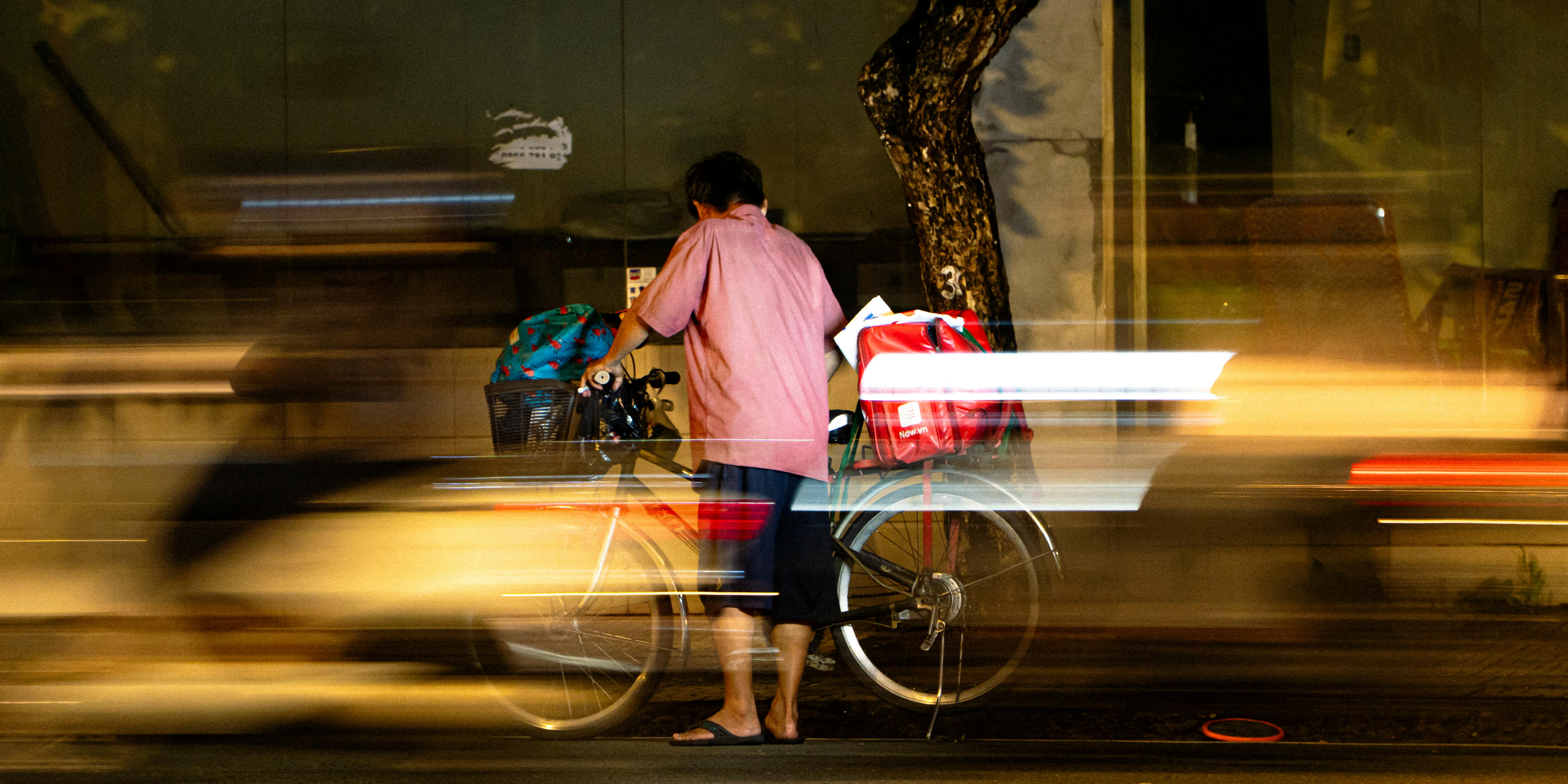 Outdoor photographer with tripod and filters set up beside a river